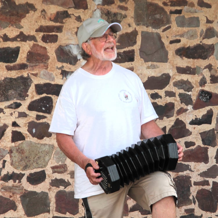 Jerry Bix plays his concertina for the crowds attending the folk festival in Carhampton. PHOTO: George Ody.