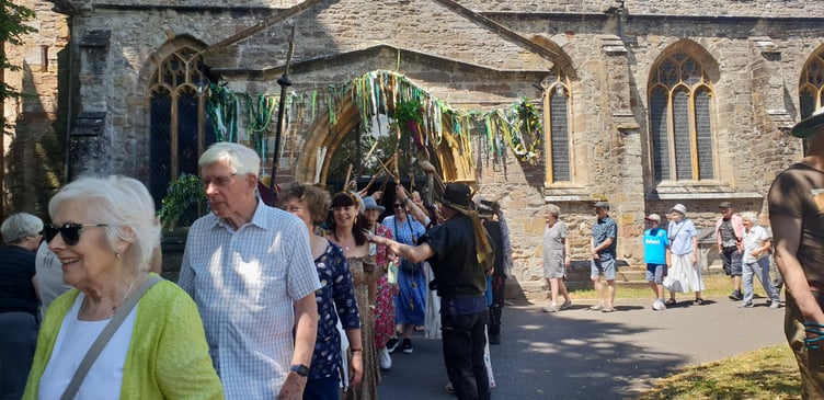 After circling St John's Church visitors made their way through an archway of Morris dancer staves.