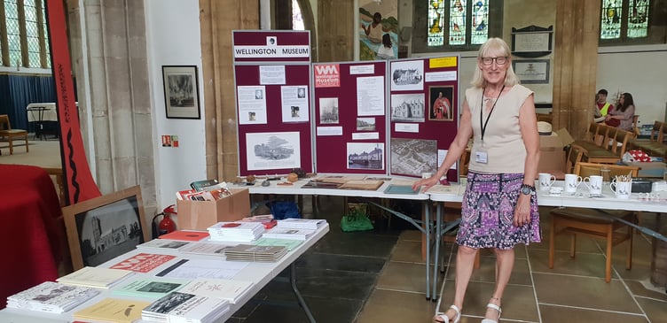 Christine Williams with the Wellington Museum stall for St John's Church patronal festival.