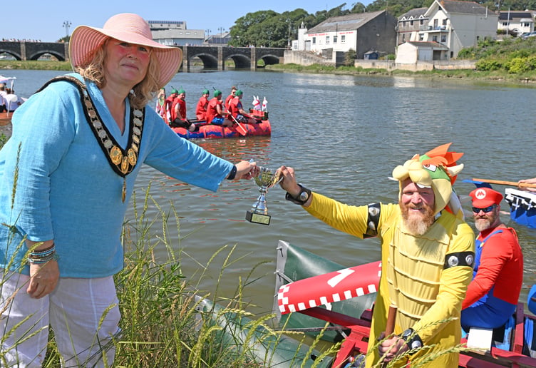 Not content with trying to take Princess Peach from Mario, Bowser seizes the opportunity to swipe the trophy for the long race from Cllr Jules Metcalfe, the mayor of Wadebridge (Picture: Adrian Jasper)