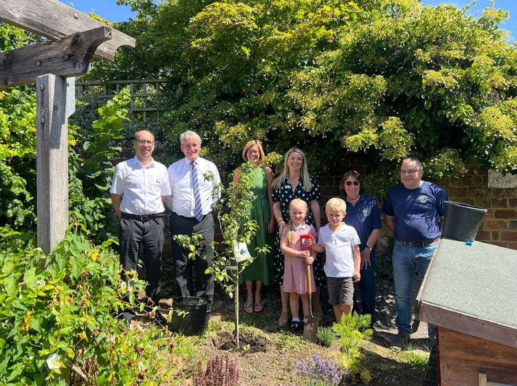 Planting a tree in the sensory area with pupils Maeve White and Nathaniel St John are, from left, headteacher Richard Mead, East Hampshire MP Damian Hinds, incoming headteacher Stacey Serdet, chair of governors Roisin Pope, Alton Lions Club Santa committee member Marie Spurdle and Alton Lions Club president Paul Taroni, July 10th 2026.