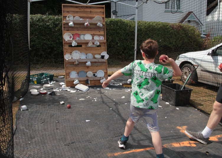 Alfie Elston, aged seven, has fun smashing plates without getting into trouble at Porlock Country Fair. PHOTO: George Ody.
