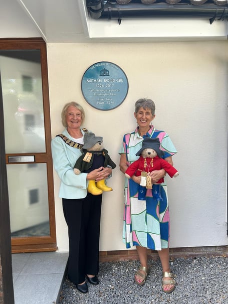 Haslemere Mayor Jacquie Keen and Michael Bond’s daughter, Karen Jankel, hold Paddington Bears at the unveiling of a blue plaque marking the author’s former home in Haslemere. Credit: Dawn Brown.
