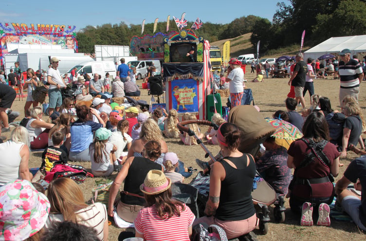 Children, and adults, at this year's Dunster Show prove Punch and Judy is as popular as ever. PHOTO: George Ody.