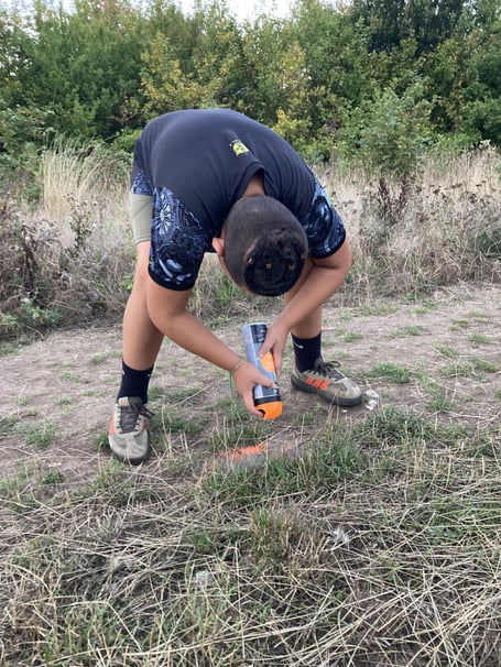 Hive Helper volunteer spraying dog poo in Runfold Ridge