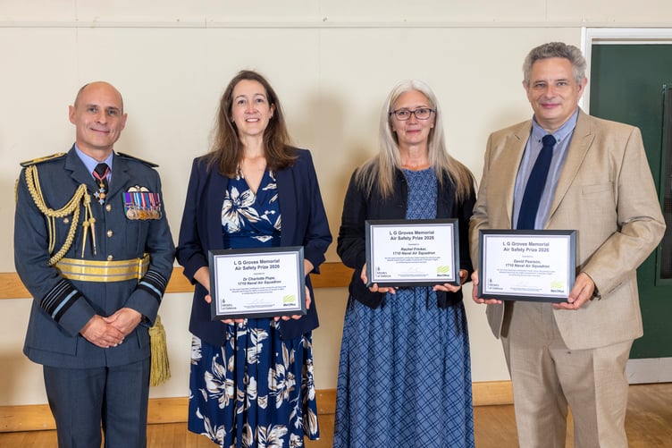 Representatives of 1710 Naval Air Squadron receive their LG Groves 2026 memorial awards in Crowcombe Village Hall from Air Marshal Mark Flewin.