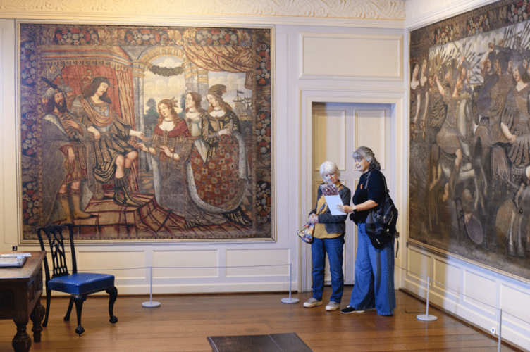 Visitors to the Dunster Castle exhibition read notes on the exhibits. PHOTO: National Trust/Steve Haywood.