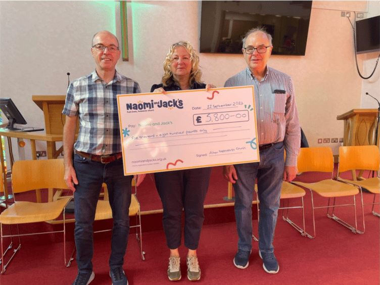 Karen Sanderson from Naomi and Jack’s receives a cheque for £5,800 raised by Alton Methodist Church from steward Alan Robb, left, and treasurer Graham Titterington, September 22nd 2026.