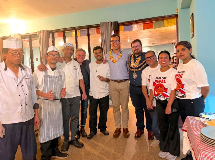 MP Noah Law and St Austell mayor Ethan Stephens, both wearing garlands, at the Gurkha Restaurant.