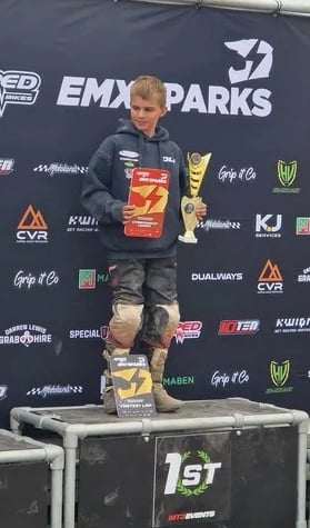Oli on the 1st place podium with his trophy.
